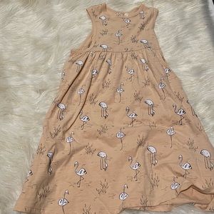 Beige girls dress w/ white flamingos. Sleeveless. Size 6-7.